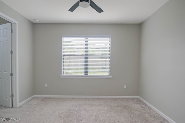 unfurnished room with ceiling fan and light colored carpet