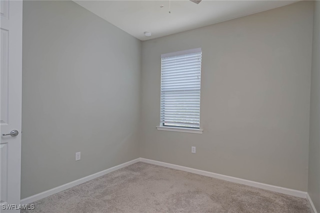 unfurnished room featuring light colored carpet and a wealth of natural light