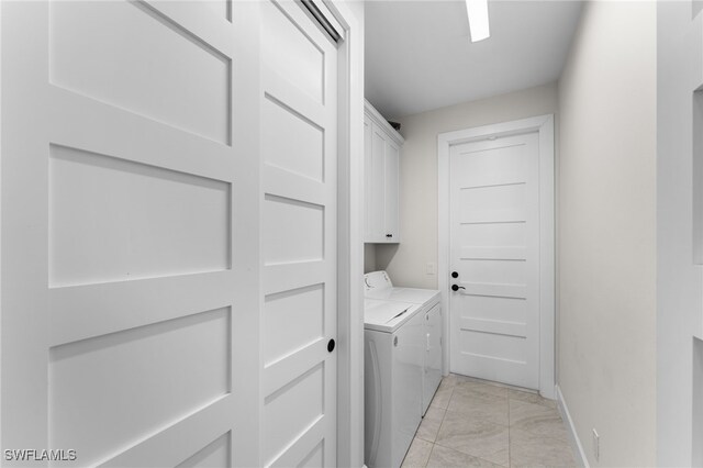 washroom with cabinets, independent washer and dryer, and light tile patterned floors