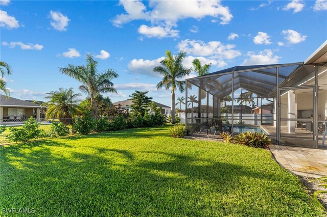 view of yard featuring a patio area and a lanai