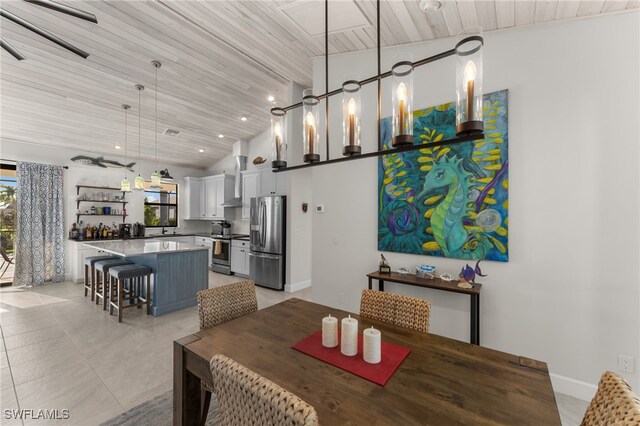 dining space with wooden ceiling and vaulted ceiling