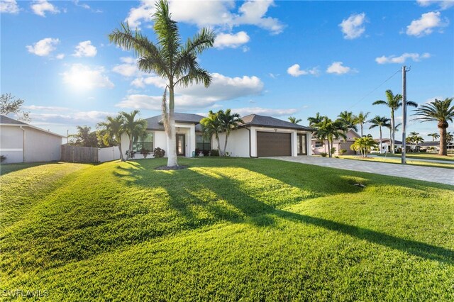 single story home with a garage and a front yard