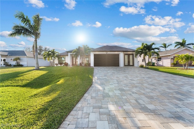 view of front of property featuring a front yard and a garage