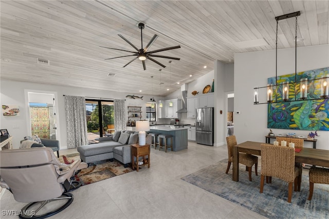 living room with ceiling fan with notable chandelier, wooden ceiling, and high vaulted ceiling