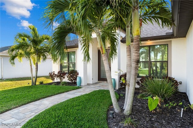 entrance to property with a lawn