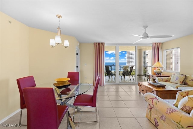 dining room with light tile patterned floors and ceiling fan with notable chandelier