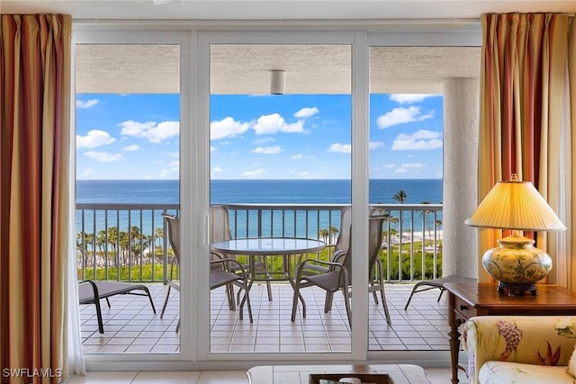 interior space featuring a water view and light tile patterned floors