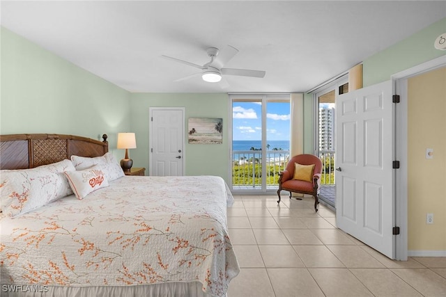 tiled bedroom featuring access to outside, floor to ceiling windows, ceiling fan, and a water view