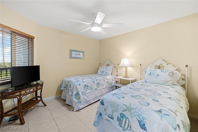 tiled bedroom featuring ceiling fan