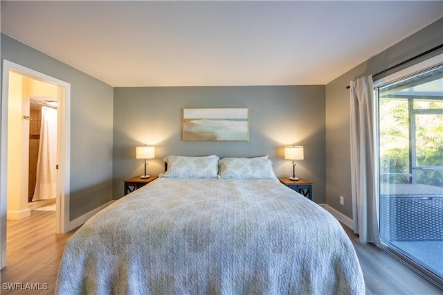 bedroom featuring hardwood / wood-style floors and access to outside