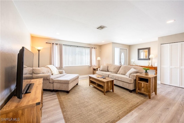 living room with light hardwood / wood-style flooring