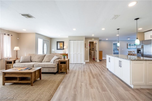 living room with light hardwood / wood-style floors