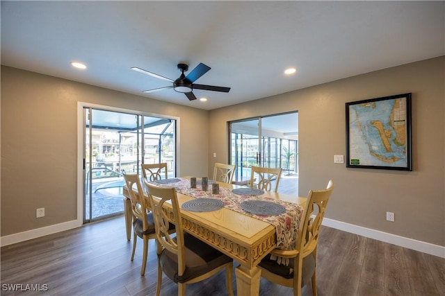 dining room with ceiling fan and dark wood-type flooring