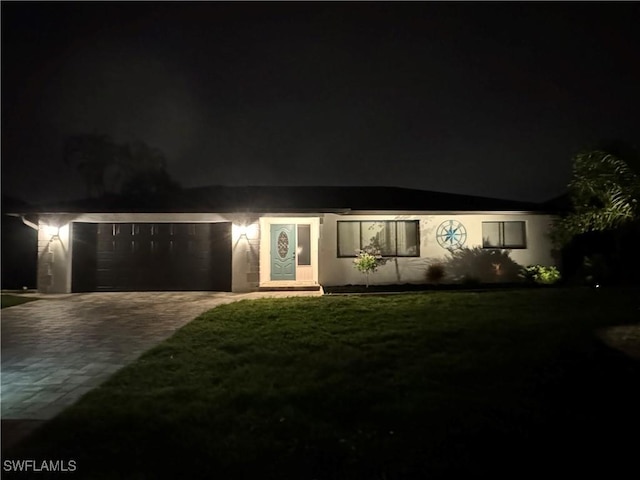 view of front of house with a lawn and a garage