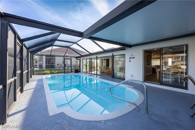 view of swimming pool featuring a patio and a lanai