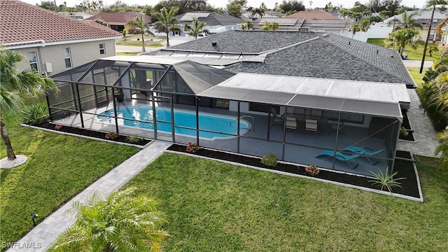 view of swimming pool with a patio area, a lanai, and a yard