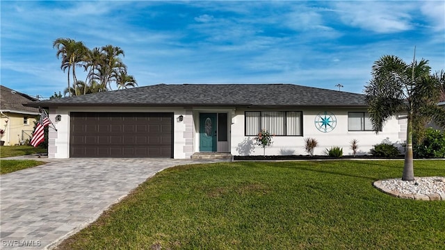 single story home featuring a front yard and a garage