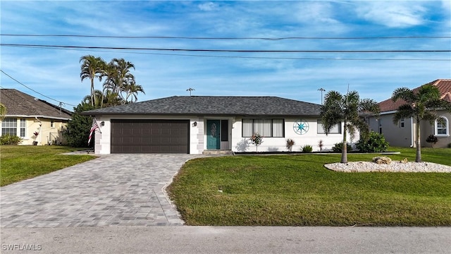 single story home featuring a garage and a front lawn