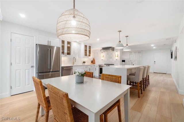 dining room featuring light hardwood / wood-style flooring and sink