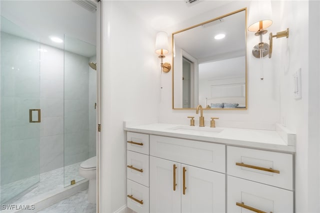 bathroom with vanity, toilet, and walk in shower