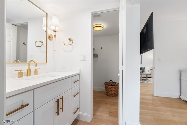 bathroom featuring vanity and hardwood / wood-style flooring