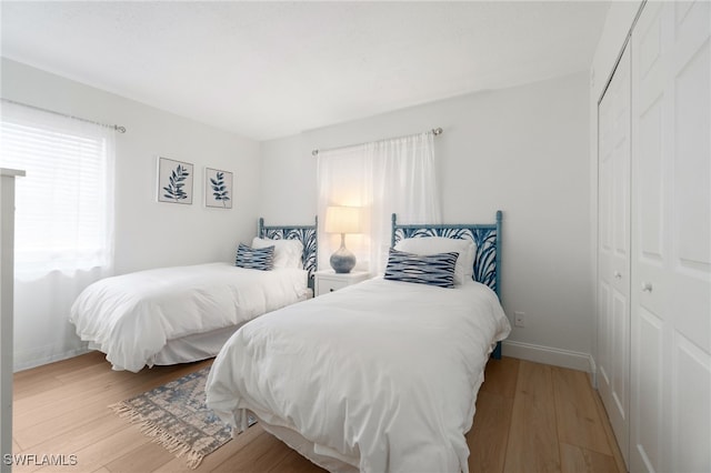 bedroom featuring light hardwood / wood-style floors and a closet