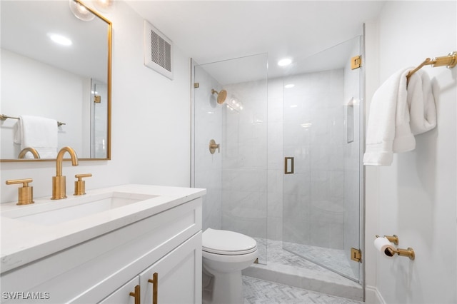 bathroom featuring vanity, toilet, and walk in shower