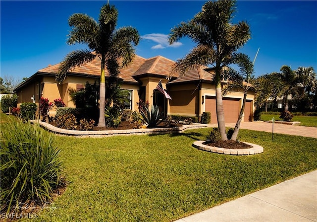 view of front of house with a garage and a front yard