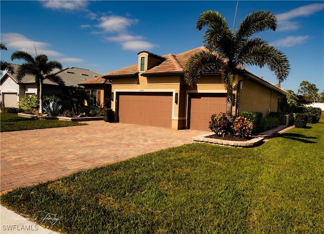 view of front facade with a garage and a front yard