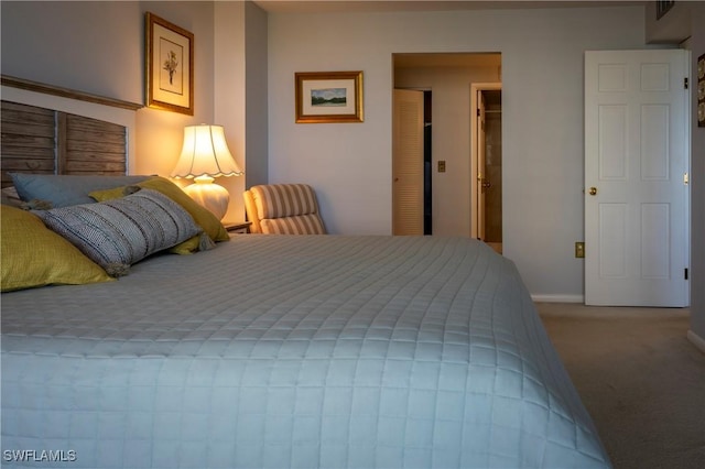 bedroom featuring carpet floors and baseboards