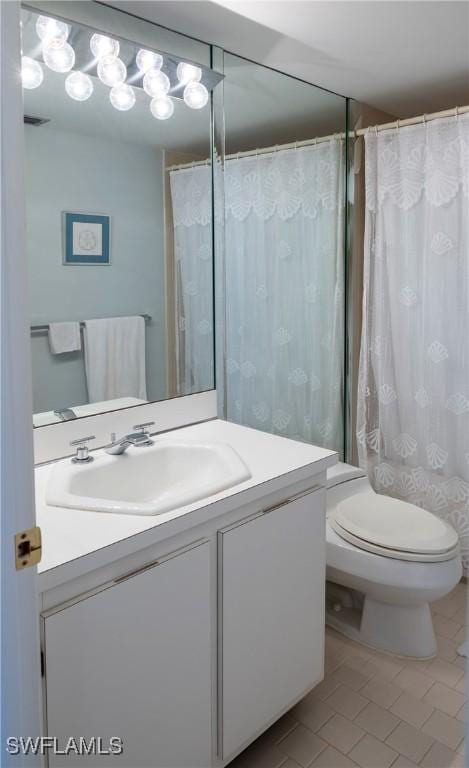 full bath featuring toilet, tile patterned floors, a shower with curtain, and vanity