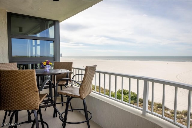 balcony with a view of the beach and a water view