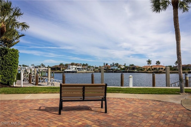 view of patio featuring a water view and a boat dock