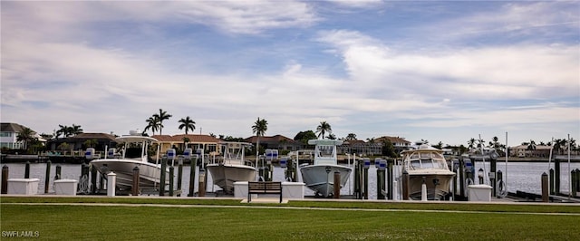 view of dock with a yard and a water view