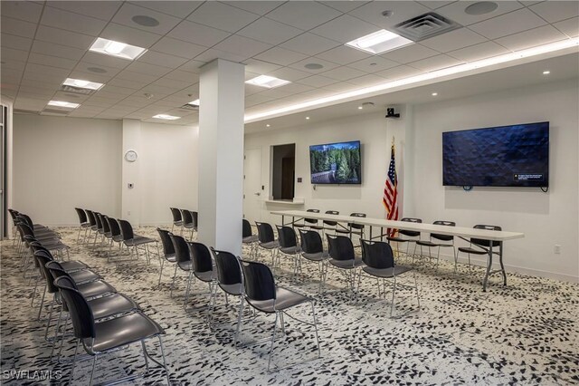 misc room featuring baseboards, visible vents, and a drop ceiling