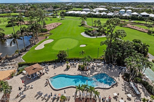 drone / aerial view featuring view of golf course and a water view