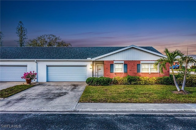 ranch-style home with a yard and a garage