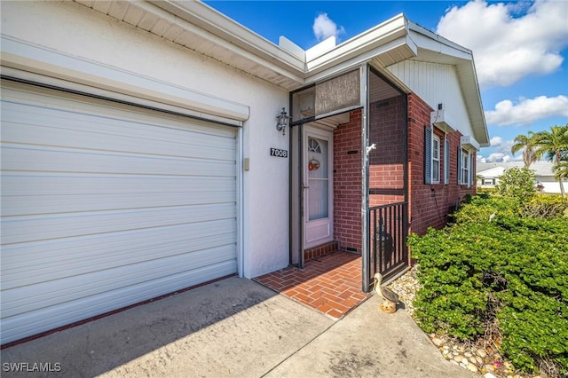 view of exterior entry featuring a garage