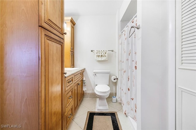 bathroom featuring toilet, vanity, and tile patterned flooring