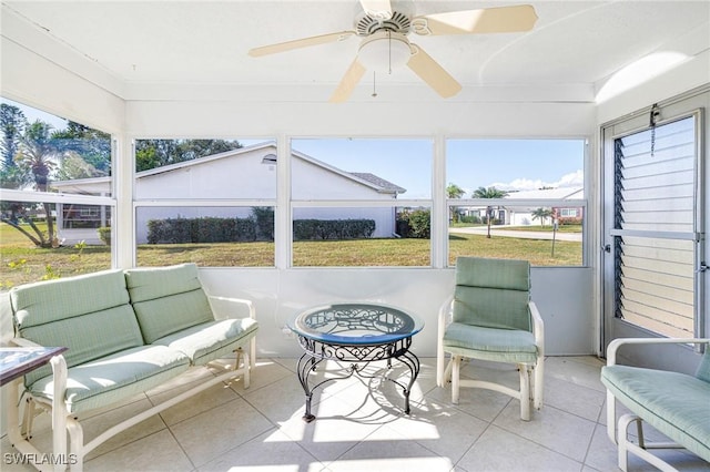 sunroom / solarium featuring ceiling fan