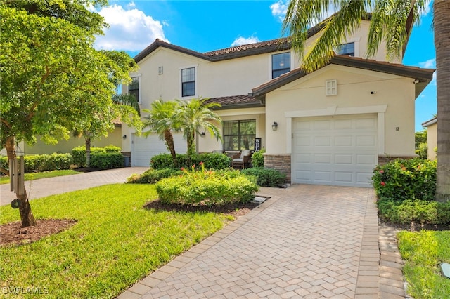 mediterranean / spanish-style home featuring a garage and a front lawn