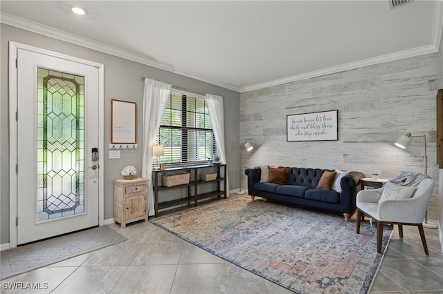 living room with tile patterned floors, crown molding, and tile walls