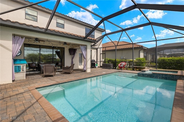 view of swimming pool featuring glass enclosure, ceiling fan, a grill, a patio area, and an in ground hot tub