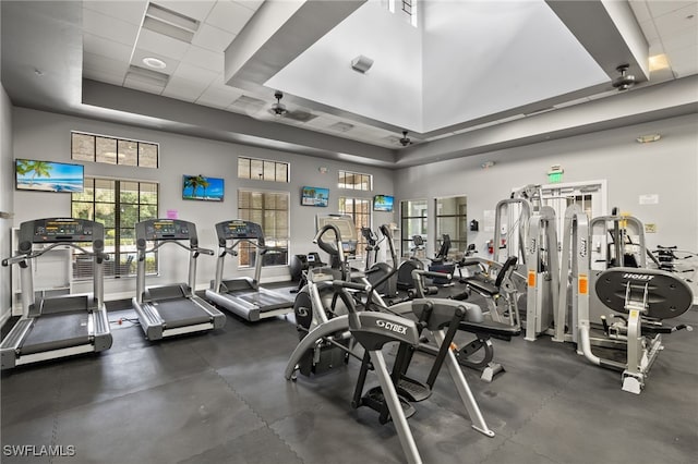 gym with a high ceiling and a paneled ceiling