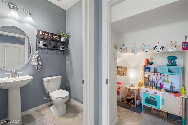 bathroom featuring tile patterned floors, sink, and toilet