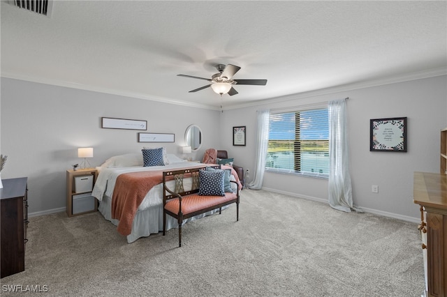 carpeted bedroom with ceiling fan and crown molding