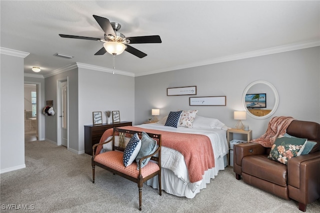 carpeted bedroom with ceiling fan, ornamental molding, and ensuite bathroom