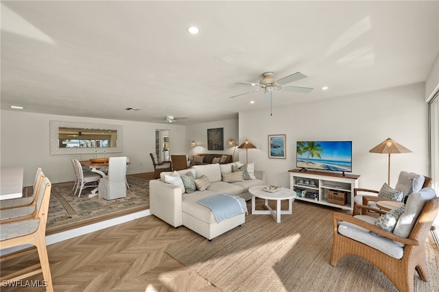 living room with ceiling fan and parquet floors