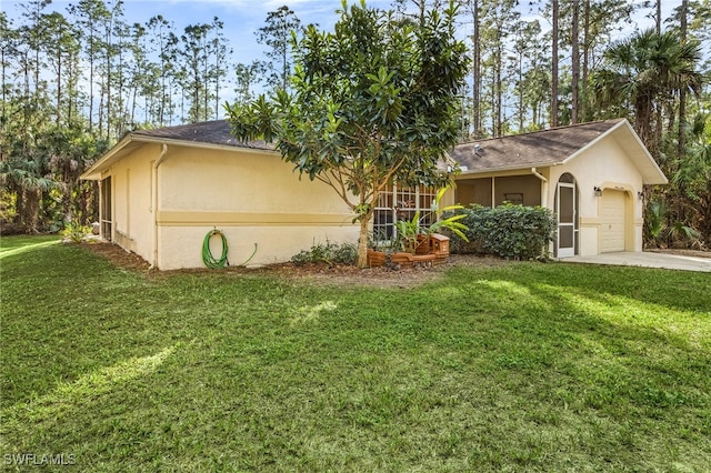 view of front of home with a garage and a front lawn