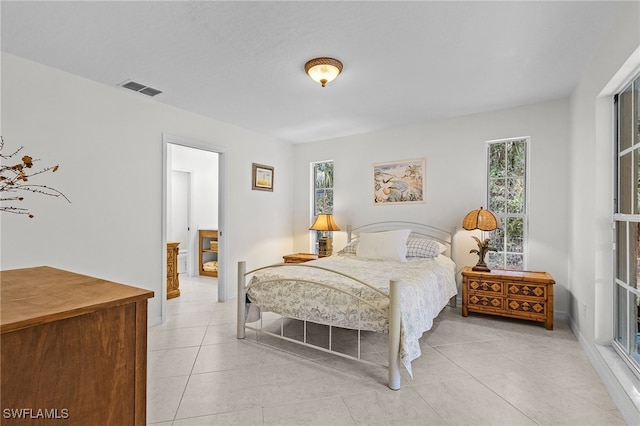 bedroom featuring light tile patterned flooring and multiple windows